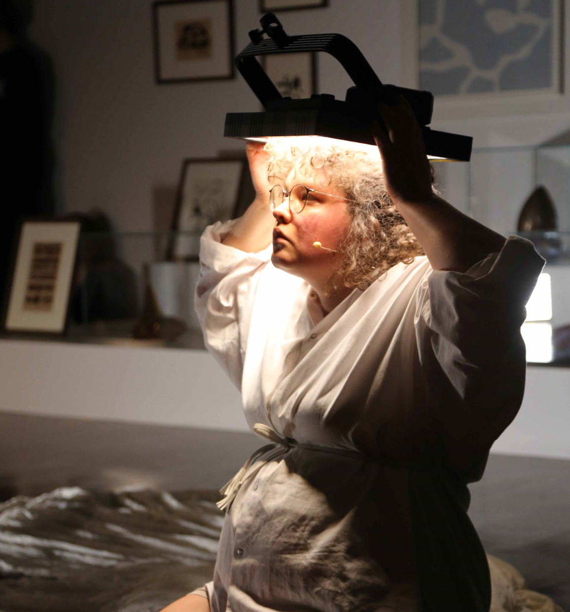eine Frau hält einen Scheinwerfer über den Kopf